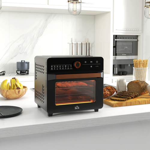Black toaster oven on a kitchen counter with food inside, surrounded by kitchen items.
